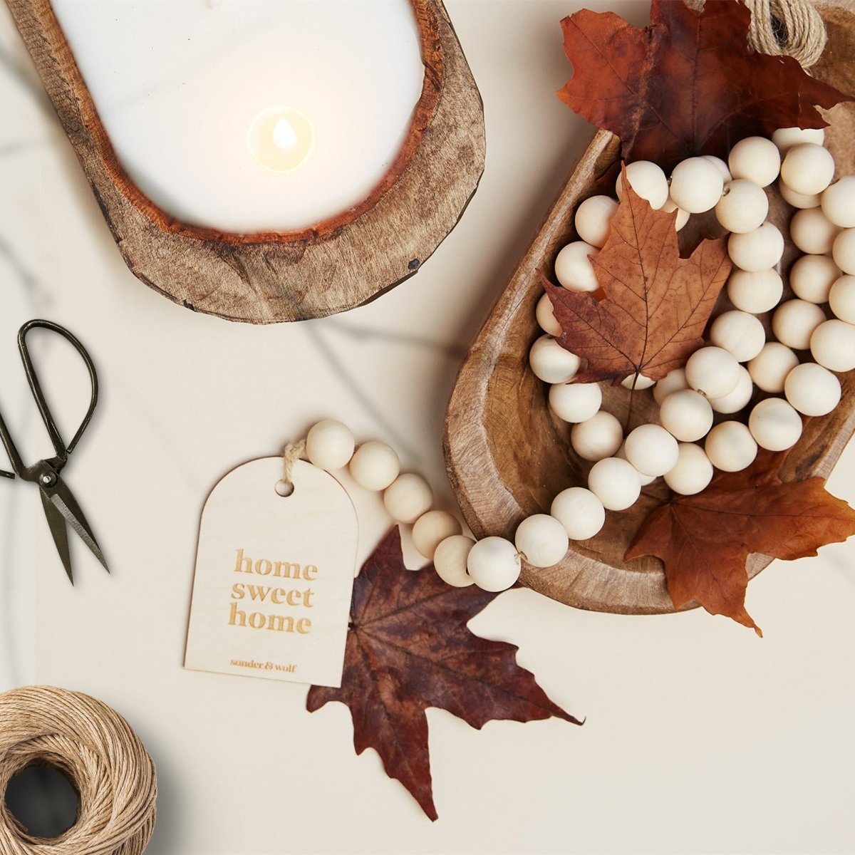 Wood Bead Garland featuring a wooden charm and jute tassel, showcasing natural beads and rustic charm.