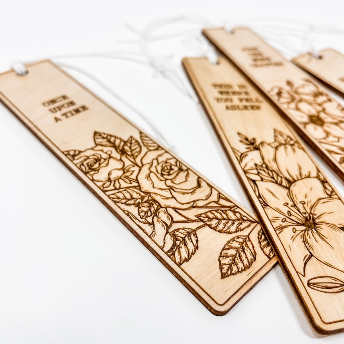 A beautifully crafted wooden bookmark with floral engravings and inspirational quotes, perfect for book lovers.