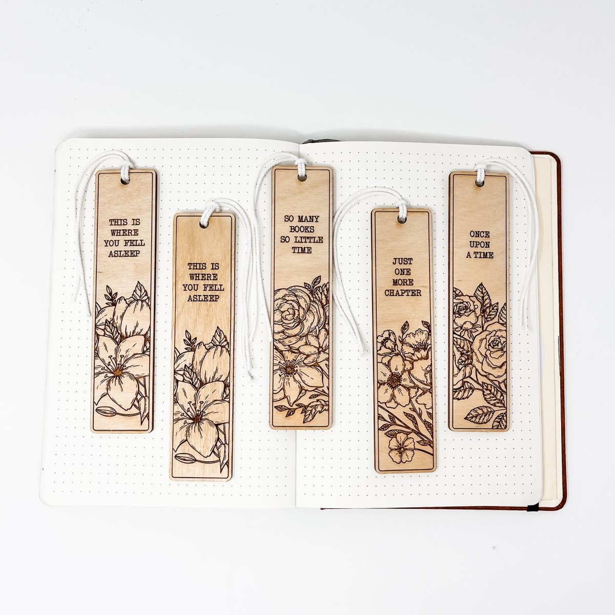 A beautifully crafted wooden bookmark with floral engravings and inspirational quotes, perfect for book lovers.