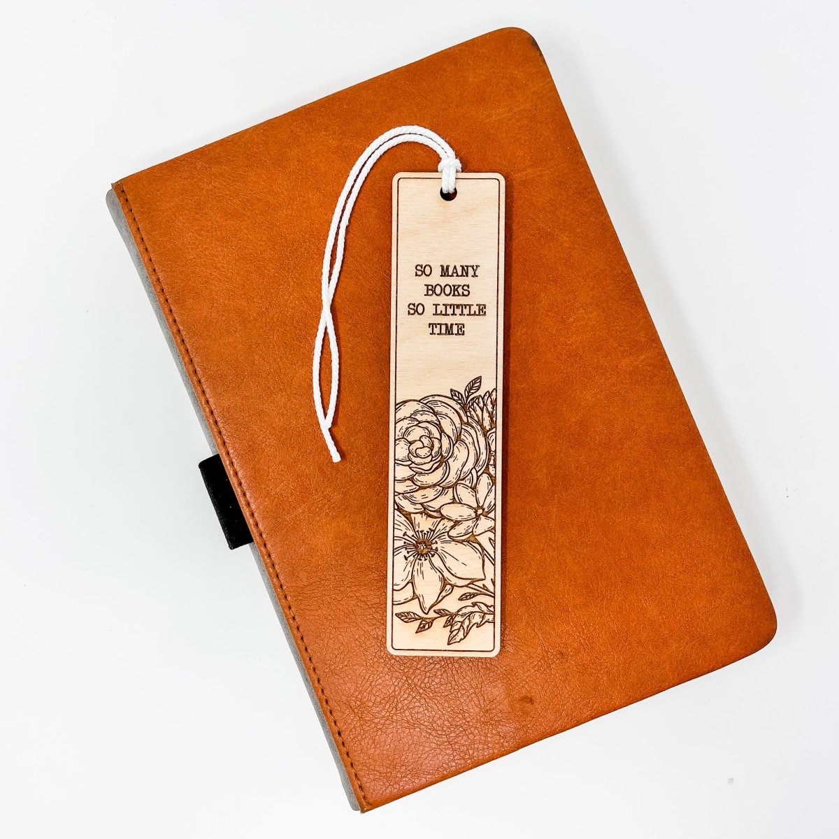 A beautifully crafted wooden bookmark with floral engravings and inspirational quotes, perfect for book lovers.