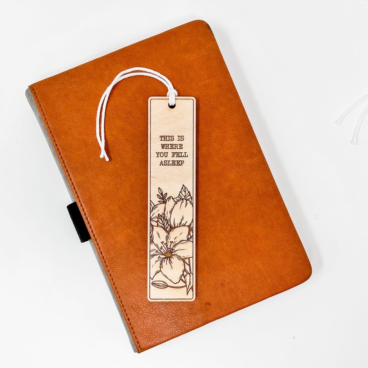 A beautifully crafted wooden bookmark with floral engravings and inspirational quotes, perfect for book lovers.