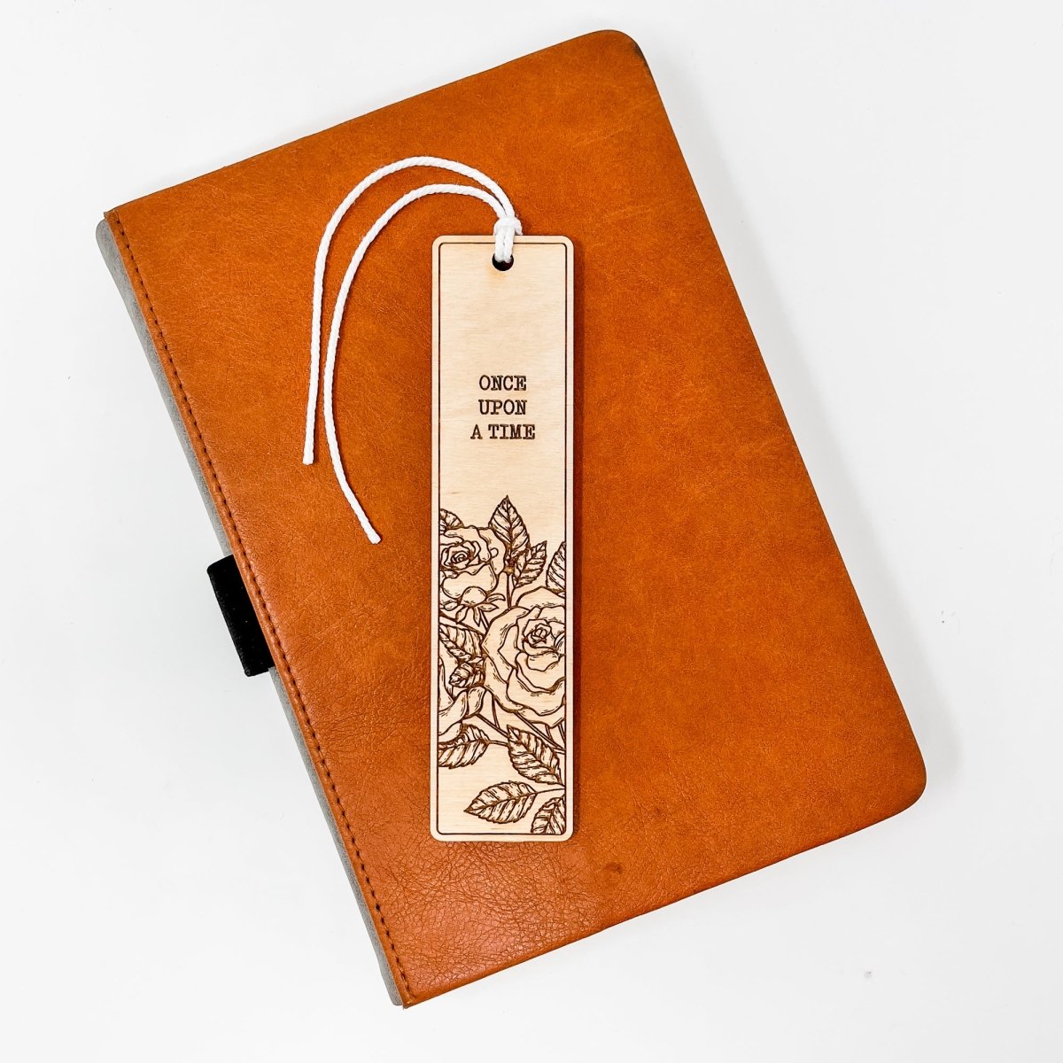 A beautifully crafted wooden bookmark with floral engravings and inspirational quotes, perfect for book lovers.