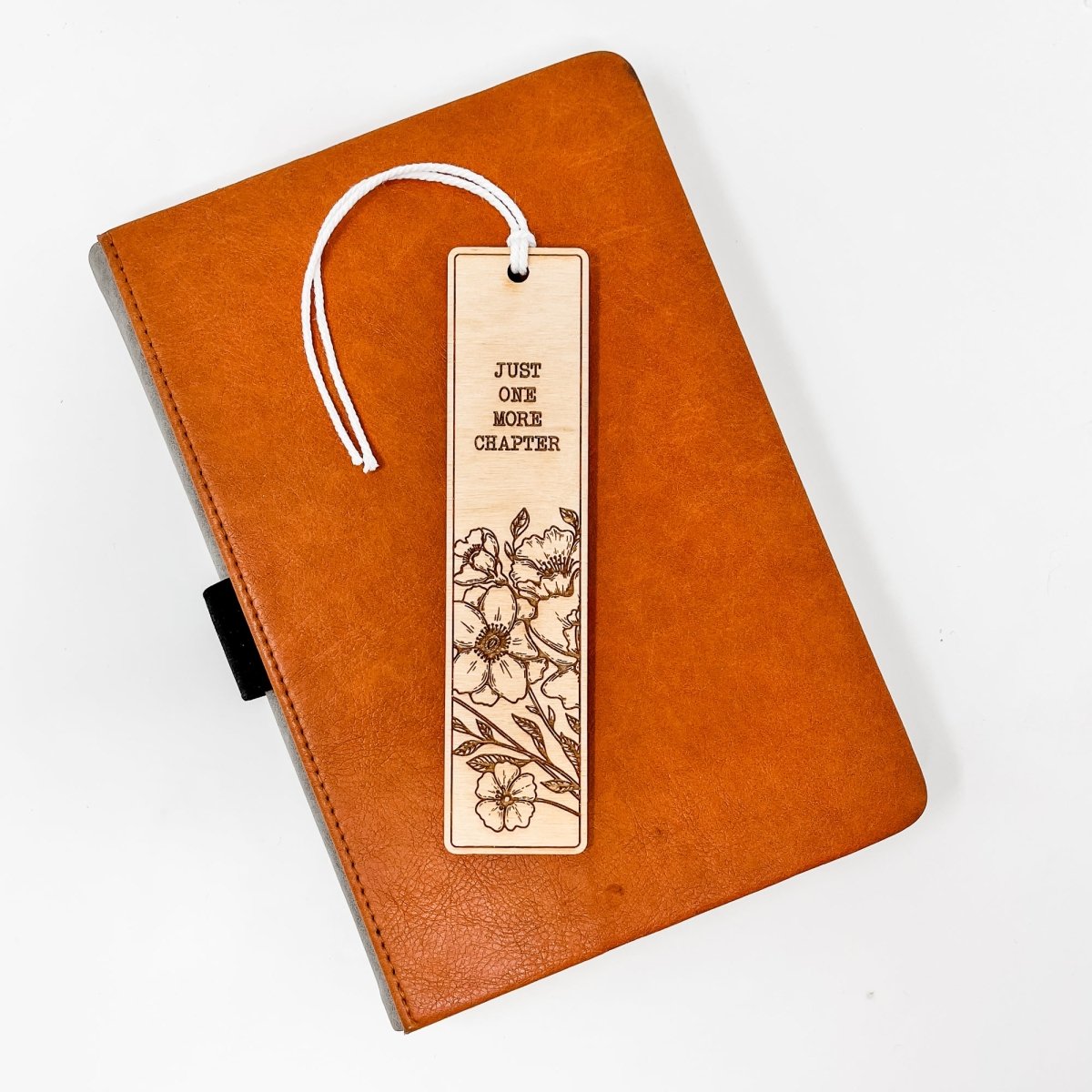 A beautifully crafted wooden bookmark with floral engravings and inspirational quotes, perfect for book lovers.