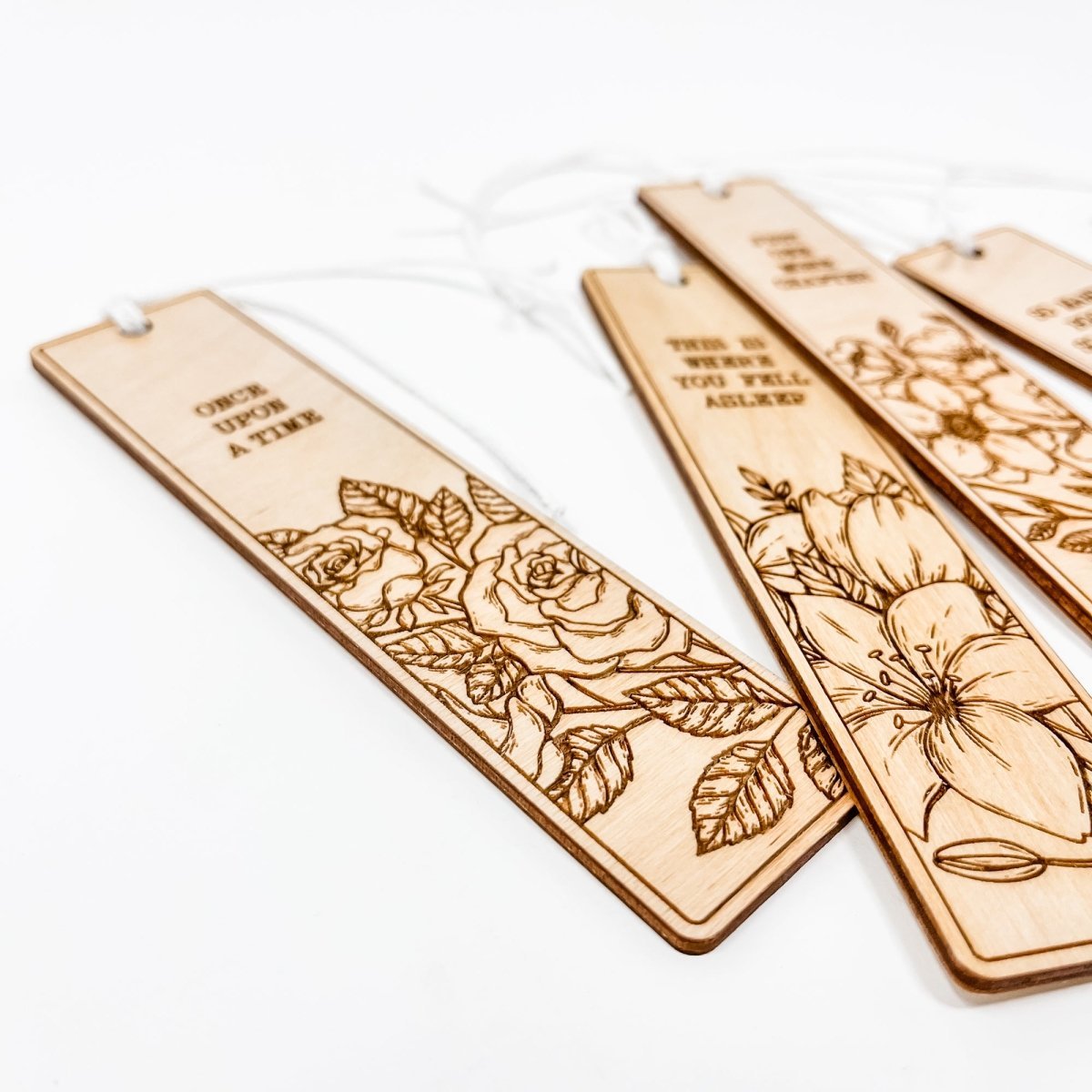 A beautifully crafted wooden bookmark with floral engravings and inspirational quotes, perfect for book lovers.