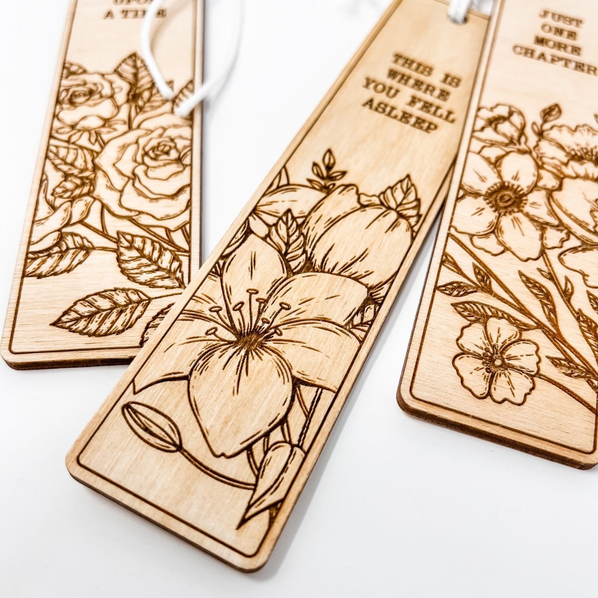 A beautifully crafted wooden bookmark with floral engravings and inspirational quotes, perfect for book lovers.