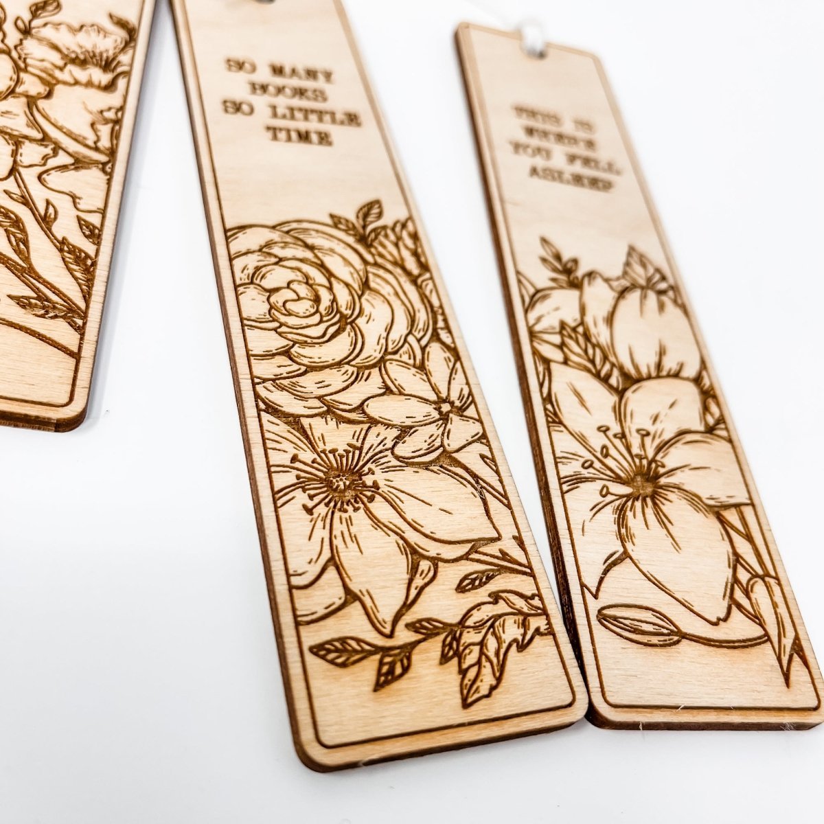 A beautifully crafted wooden bookmark with floral engravings and inspirational quotes, perfect for book lovers.