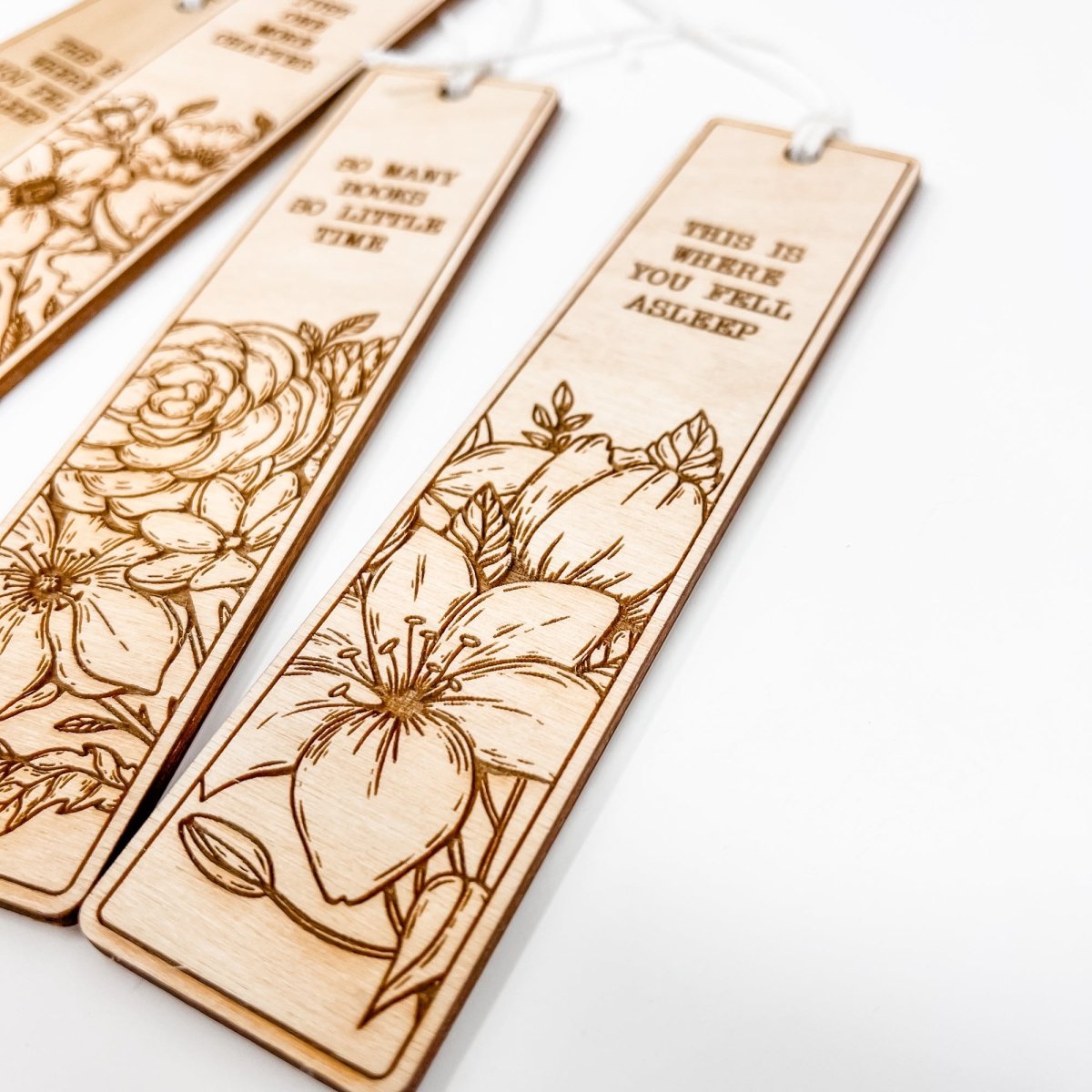 A beautifully crafted wooden bookmark with floral engravings and inspirational quotes, perfect for book lovers.