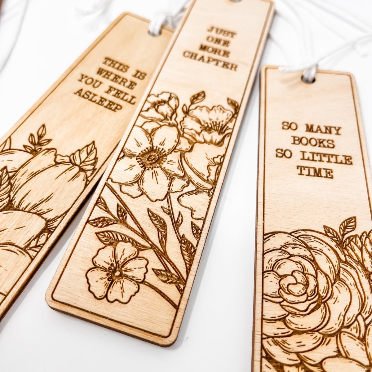 A beautifully crafted wooden bookmark with floral engravings and inspirational quotes, perfect for book lovers.