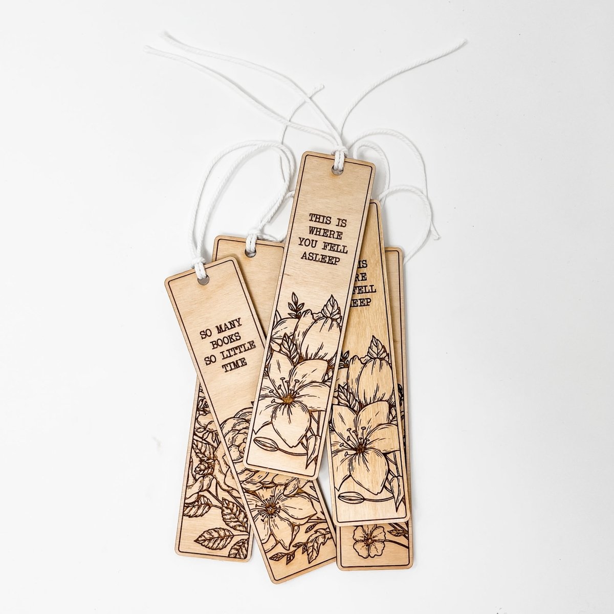 A beautifully crafted wooden bookmark with floral engravings and inspirational quotes, perfect for book lovers.