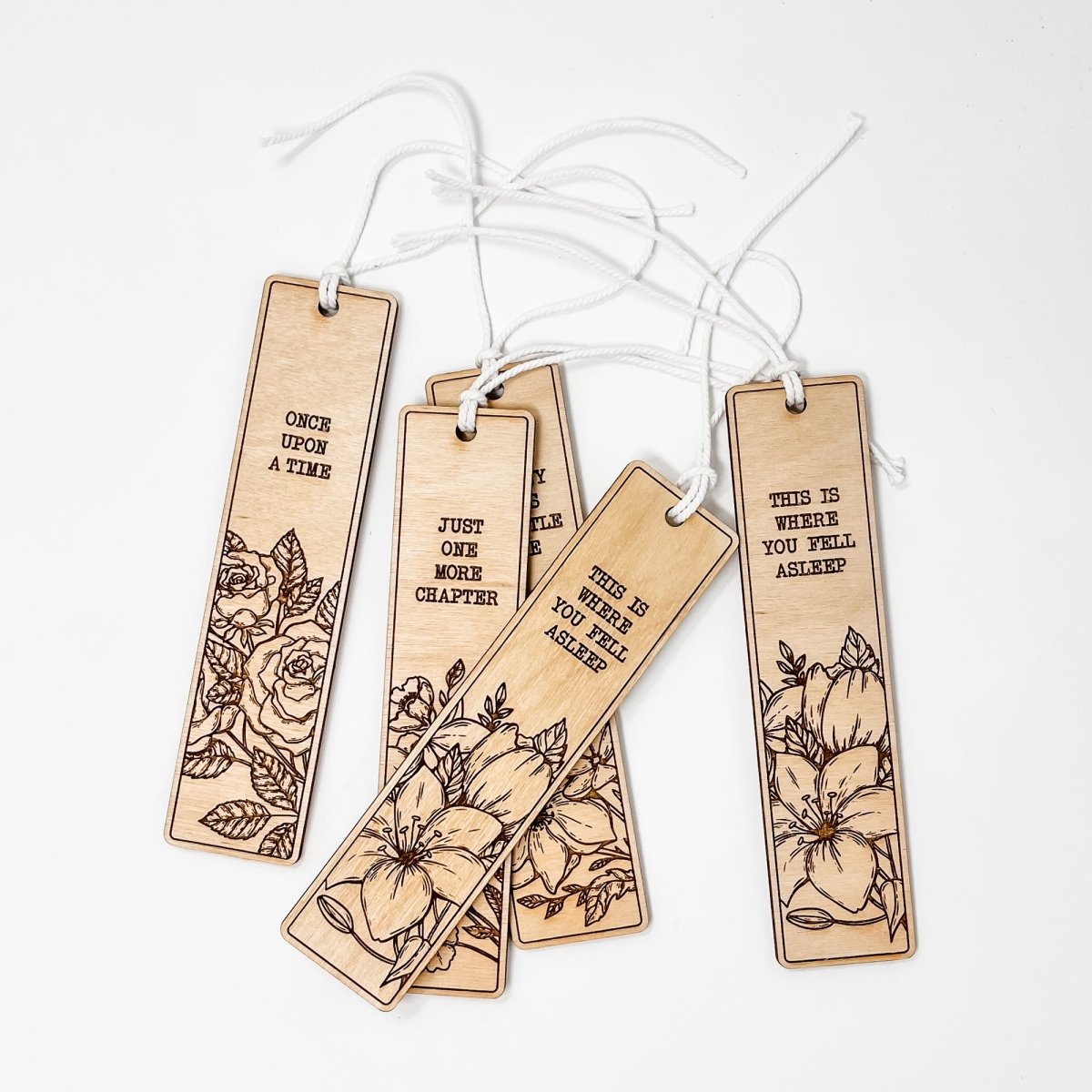 A beautifully crafted wooden bookmark with floral engravings and inspirational quotes, perfect for book lovers.