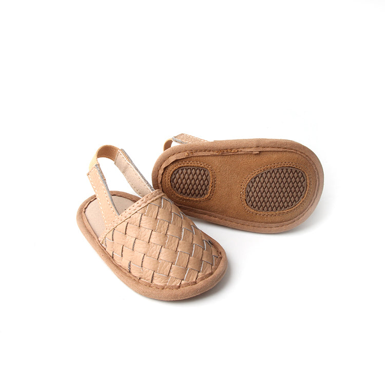 A pair of stylish woven leather sandals in Tawny and Latte colors, designed for toddlers with soft soles and ankle strap buckles.