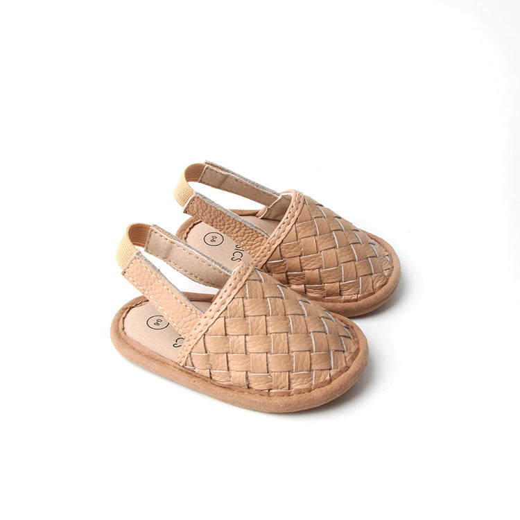 A pair of stylish woven leather sandals in Tawny and Latte colors, designed for toddlers with soft soles and ankle strap buckles.