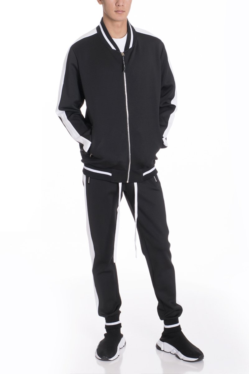 RALLY TRACK SET in black and white featuring a regular fit, ribbed elastic waist, and tug-free zipper, ideal for active lifestyles.