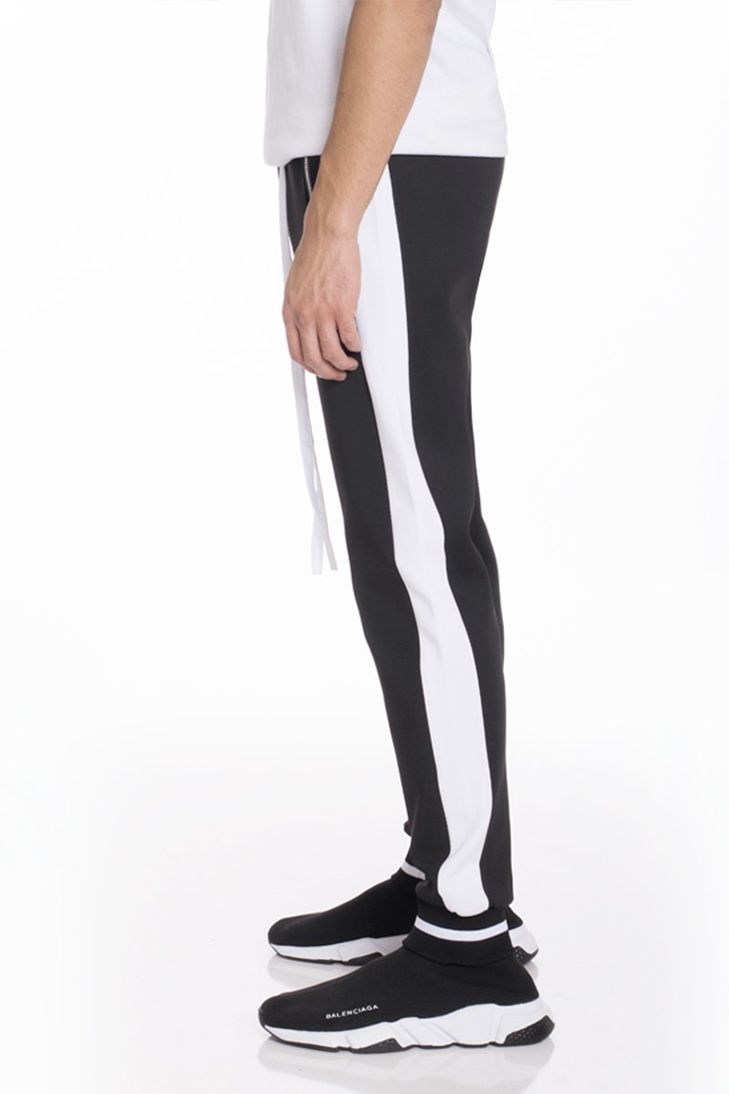 RALLY TRACK SET in black and white featuring a regular fit, ribbed elastic waist, and tug-free zipper, ideal for active lifestyles.