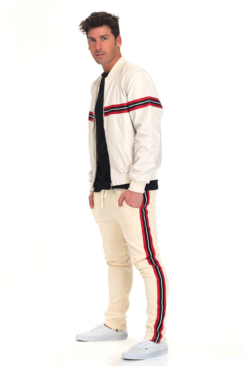 Beige SHIELD SET featuring a padded bomber jacket with tape detail, standard pockets, and hidden ankle zipper, displayed on a model.