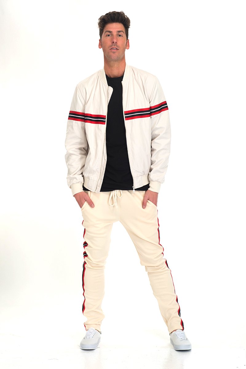 Beige SHIELD SET featuring a padded bomber jacket with tape detail, standard pockets, and hidden ankle zipper, displayed on a model.