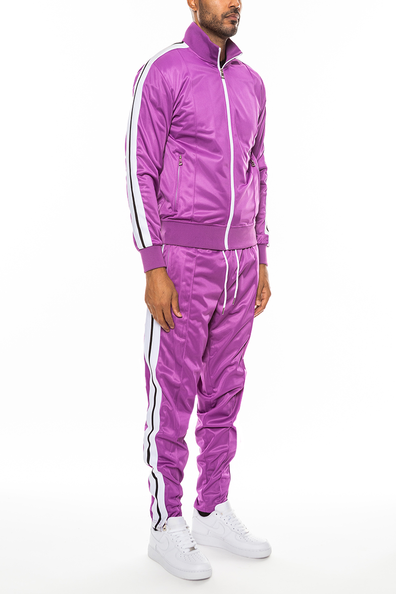 A stylish Striped Tape Front Pleat Track Suit featuring a full zip jacket, elastic waist, and ankle zippers, perfect for casual and athletic wear.