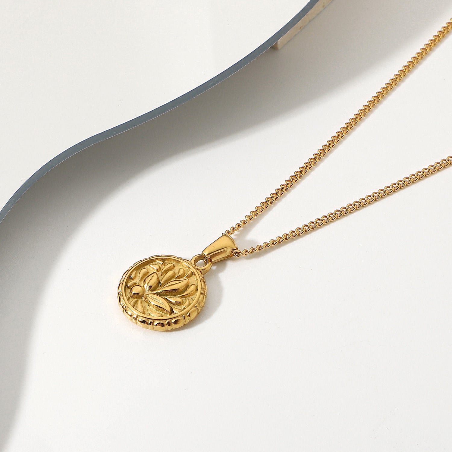 18k Gold Plated 316L Stainless Steel Flower Coin Pendant Medallion with intricate flower design.