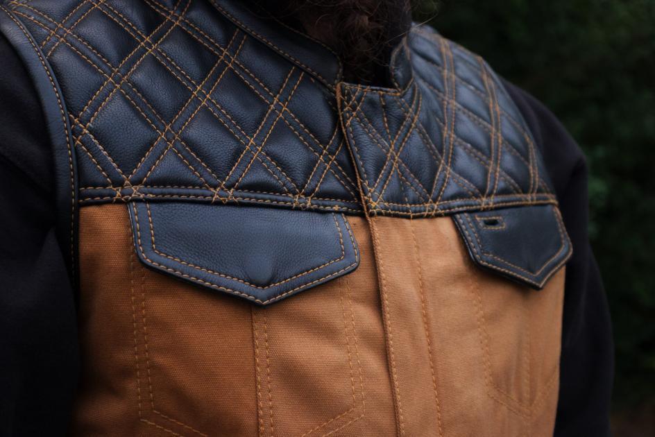 49/51 Hunt Club Limited Edition vest featuring tan stitching, durable duck canvas, and diamond quilted cowhide leather.