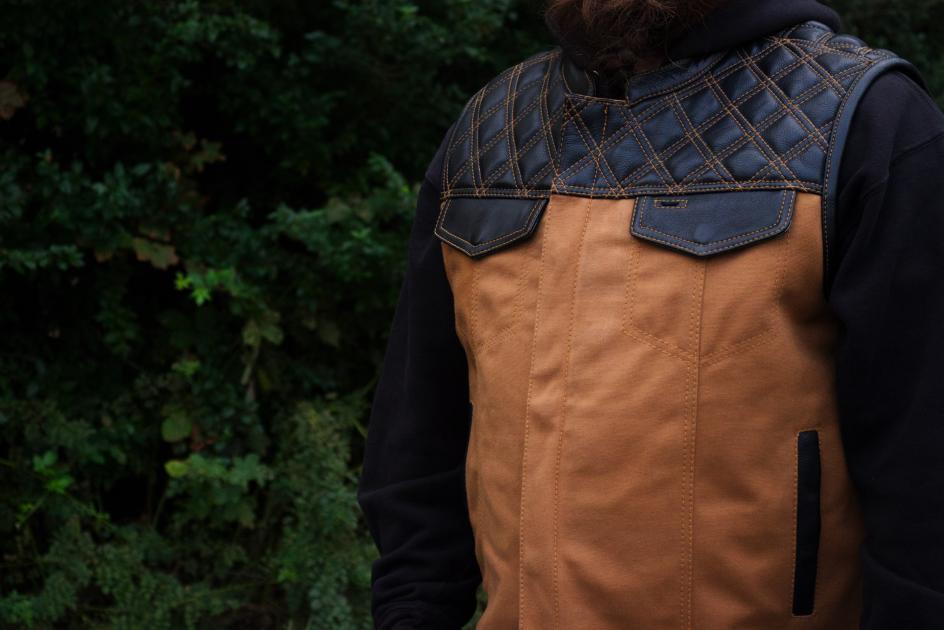 49/51 Hunt Club Limited Edition vest featuring tan stitching, durable duck canvas, and diamond quilted cowhide leather.