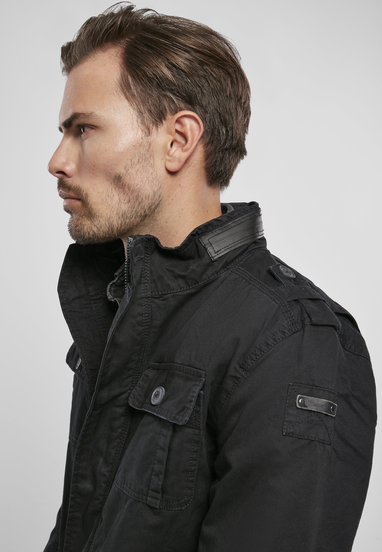 Britannia Jacket featuring a modified field design with faux leather collar and four pockets, showcasing a trendy used look.