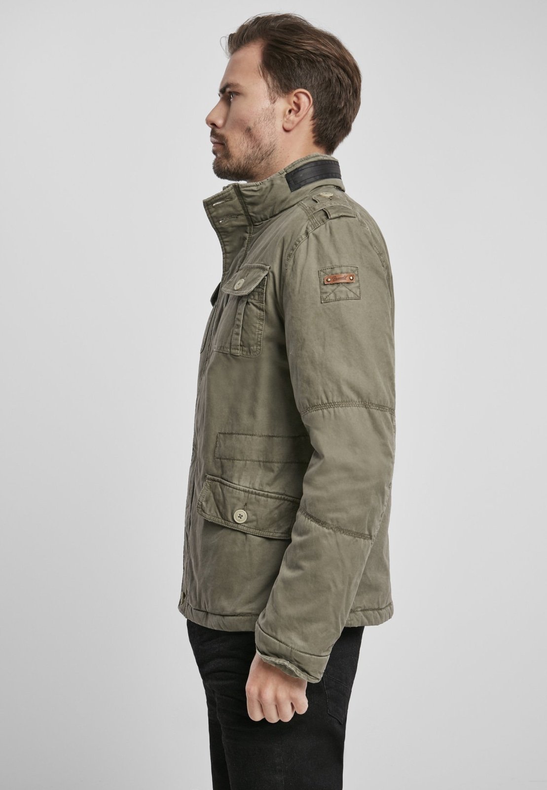 Britannia Winter Jacket featuring a modified field design, teddy lining, hidden hood in collar, and synthetic leather stand-up collar.