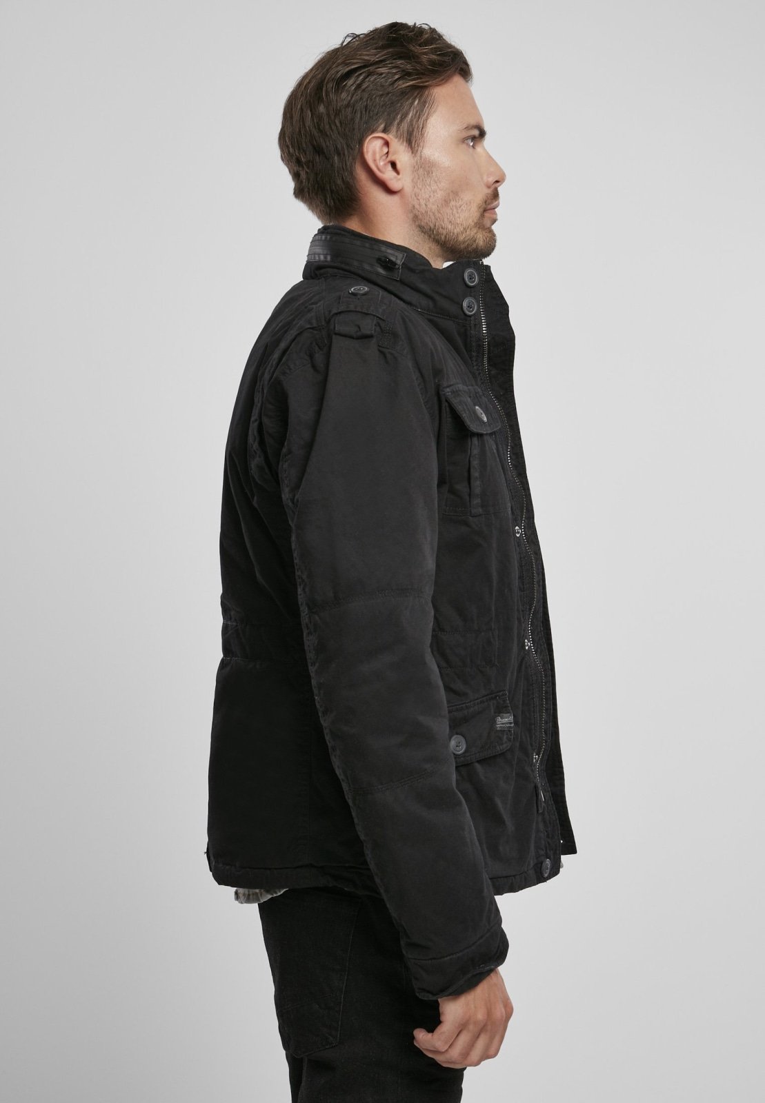 Britannia Winter Jacket featuring a modified field design, teddy lining, hidden hood in collar, and synthetic leather stand-up collar.