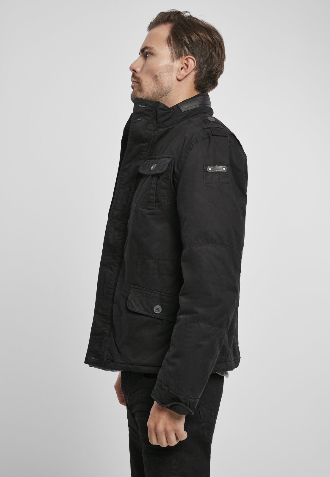 Britannia Winter Jacket featuring a modified field design, teddy lining, hidden hood in collar, and synthetic leather stand-up collar.