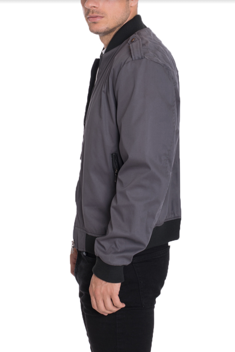 A stylish Casual Bomber Jacket made of 100% cotton, featuring contrast grey accents on the collar, waist, and cuffs, with standard pockets and shoulder strap design.