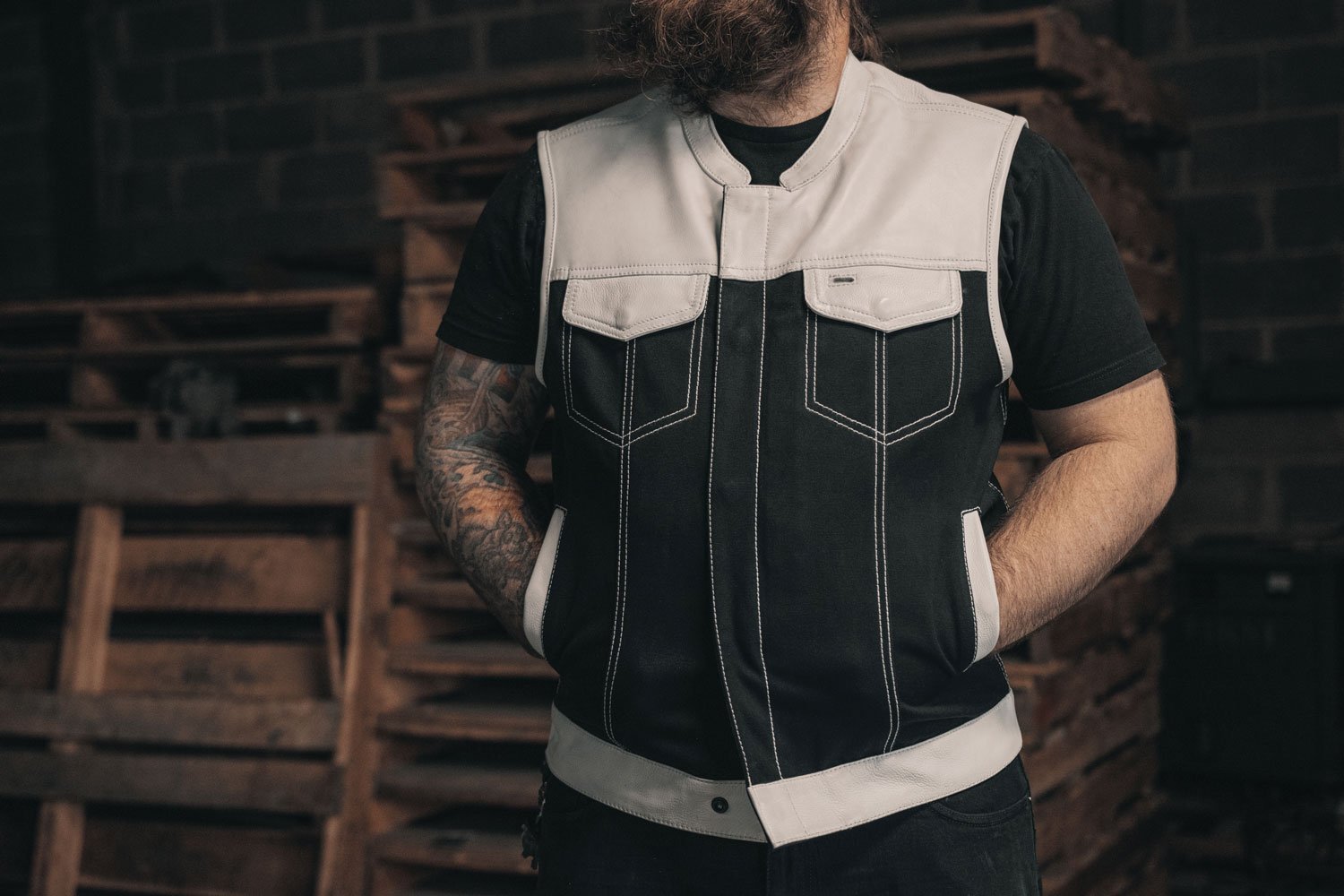 Chaplain Limited Edition vest featuring a black exterior and white paisley inner lining, with multiple pockets for functionality.