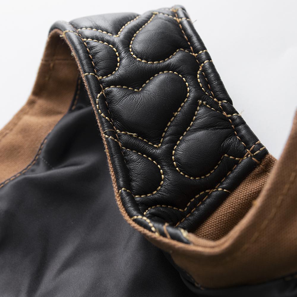 Dolly Women's Club Style Motorcycle Vest featuring leather and canvas materials with heart quilting and zippered pockets.