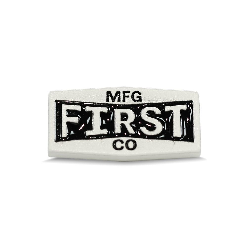 A detailed view of the First Metal Badge showcasing its unique design and high-quality metal finish.