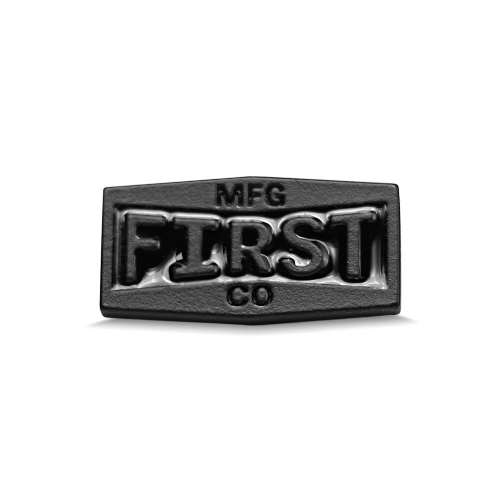 A detailed view of the First Metal Badge showcasing its unique design and high-quality metal finish.