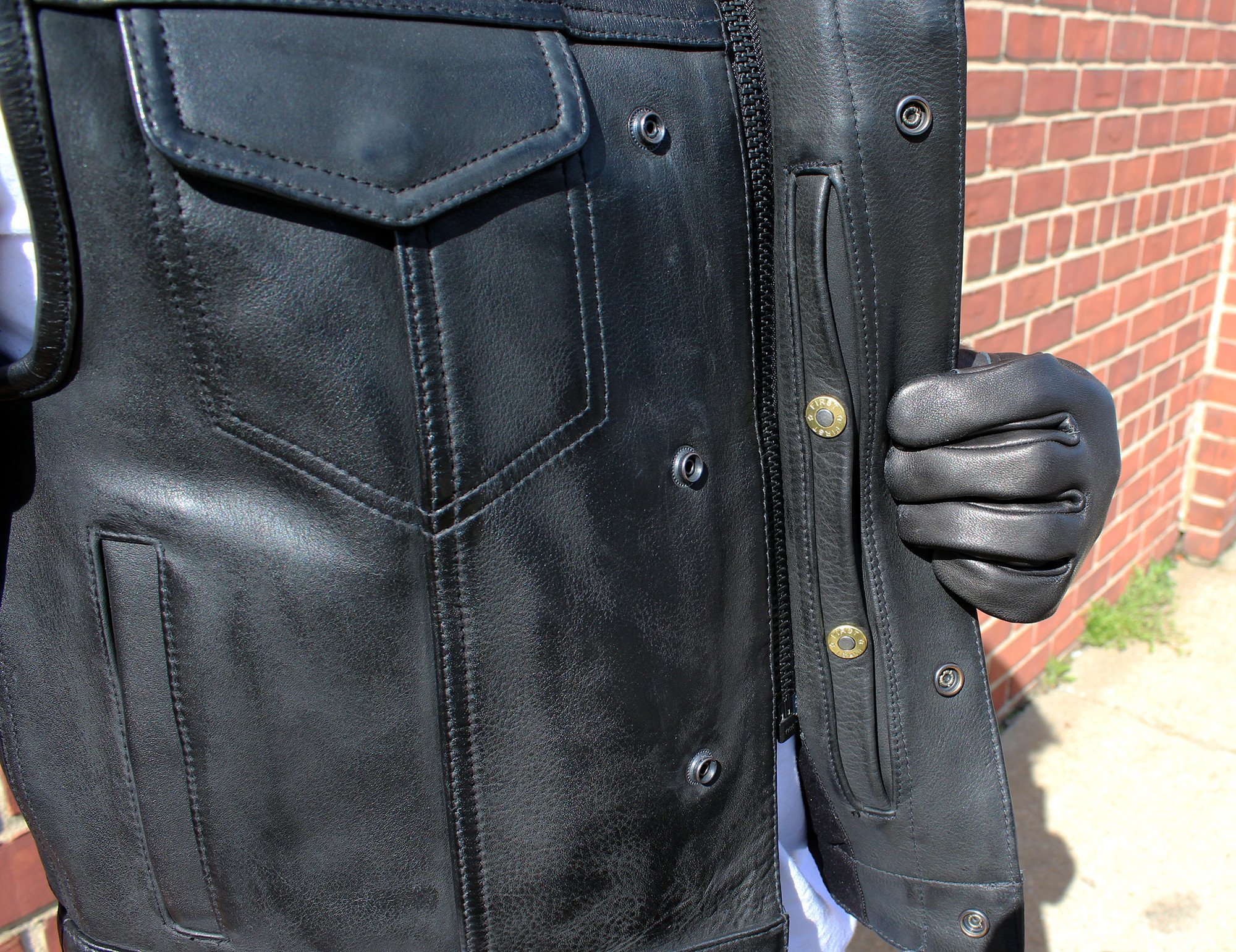 Highside Men's Motorcycle Leather Vest made from 1.3-1.4mm Platinum Cowhide, featuring covered snaps and multiple pockets.