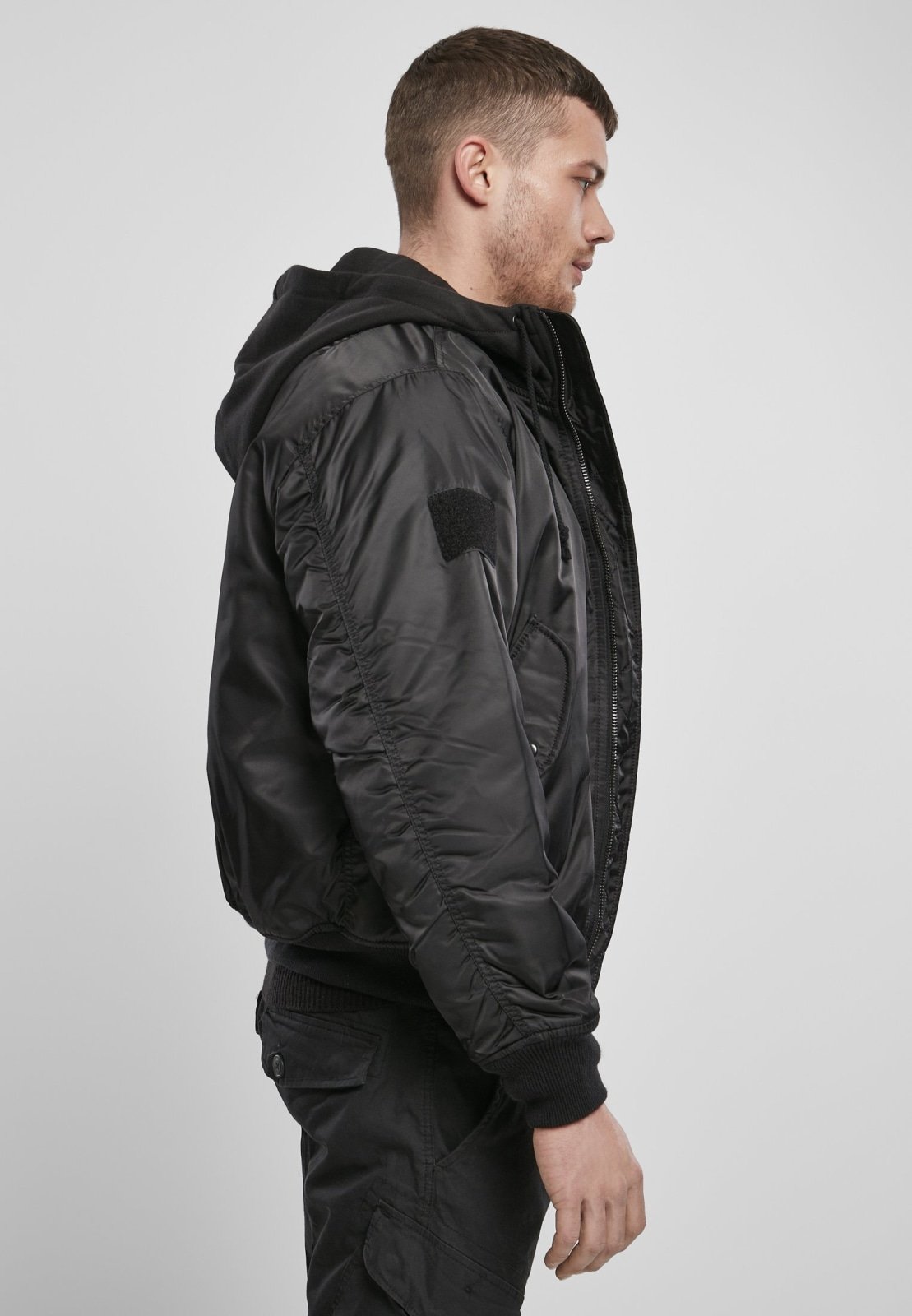 Hooded MA1 Bomber Jacket featuring a warm lining, adjustable drawstring hood, and multiple pockets, made from durable nylon material.