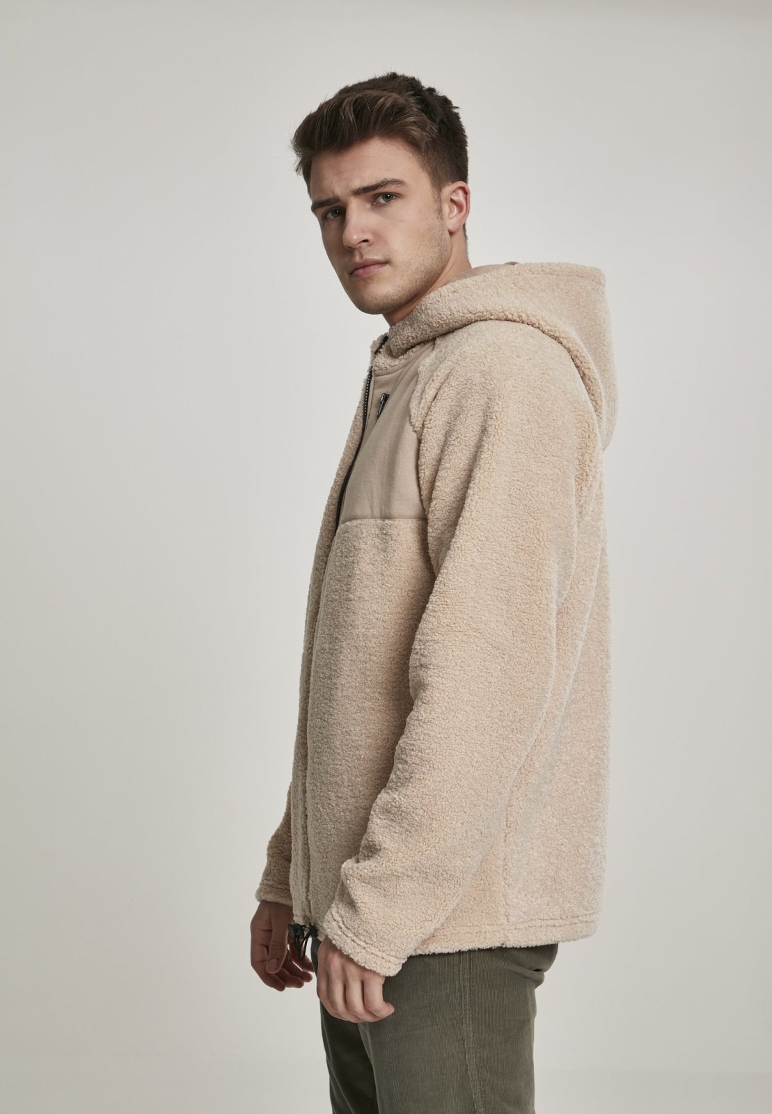 A cozy Hooded Sherpa Zip Jacket in a stylish design, featuring a soft sherpa exterior, adjustable drawstring waistband, and a practical breast pocket.