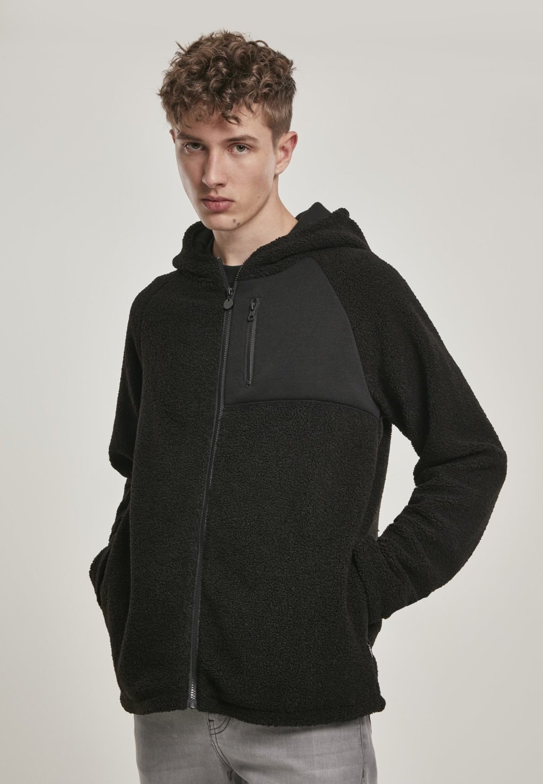 A cozy Hooded Sherpa Zip Jacket in a stylish design, featuring a soft sherpa exterior, adjustable drawstring waistband, and a practical breast pocket.