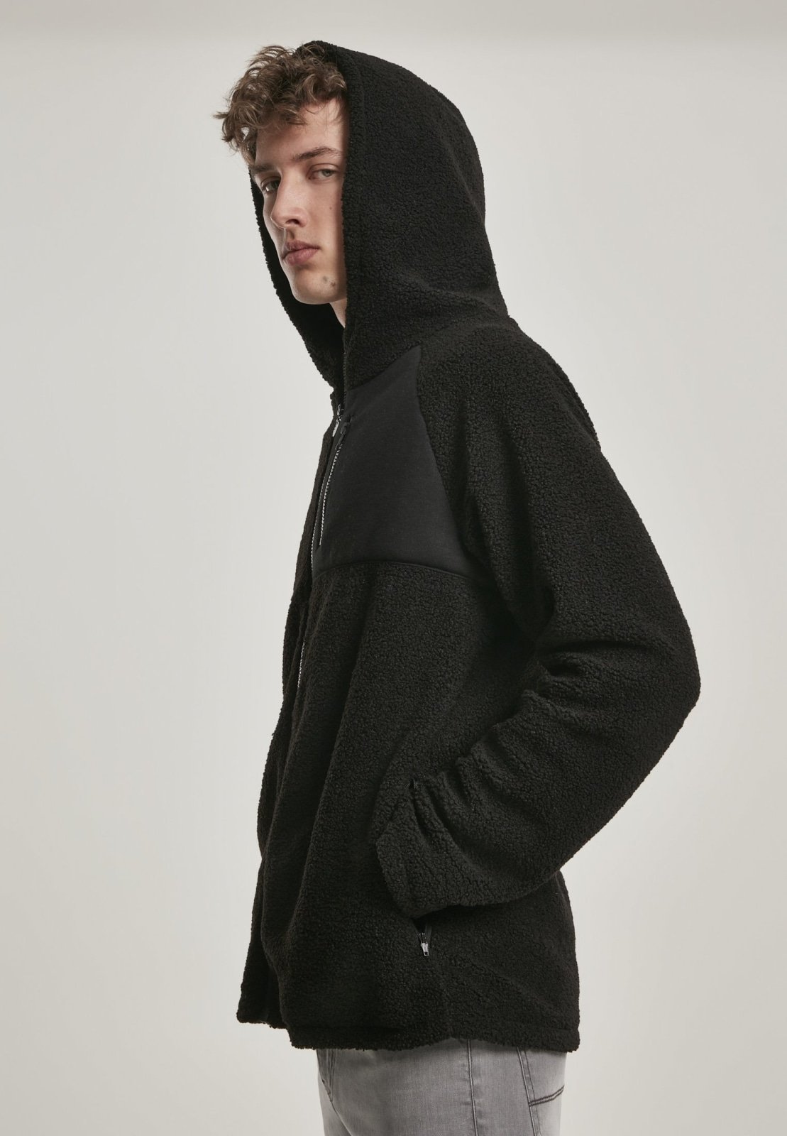 A cozy Hooded Sherpa Zip Jacket in a stylish design, featuring a soft sherpa exterior, adjustable drawstring waistband, and a practical breast pocket.