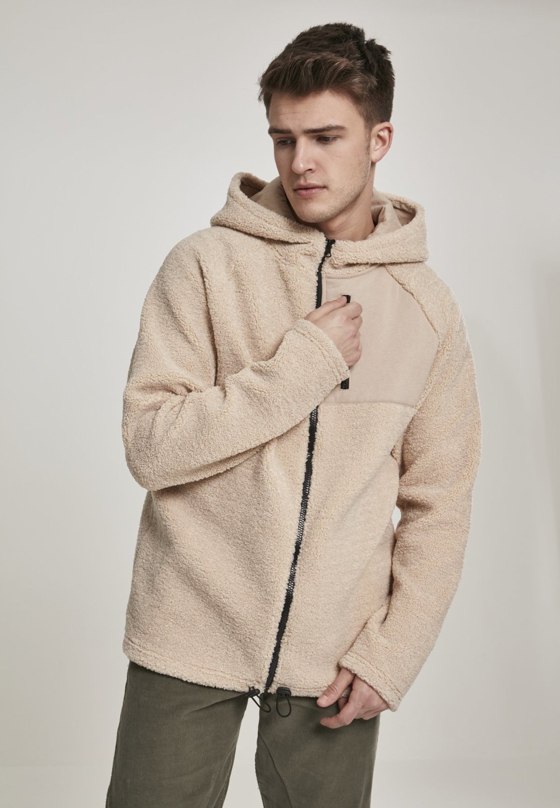 A cozy Hooded Sherpa Zip Jacket in a stylish design, featuring a soft sherpa exterior, adjustable drawstring waistband, and a practical breast pocket.