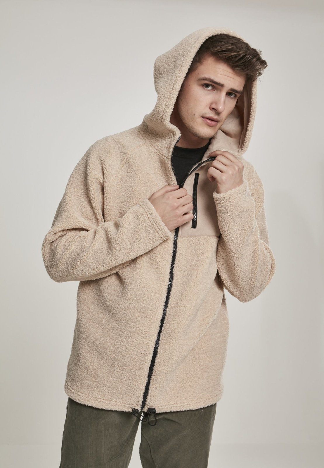 A cozy Hooded Sherpa Zip Jacket in a stylish design, featuring a soft sherpa exterior, adjustable drawstring waistband, and a practical breast pocket.