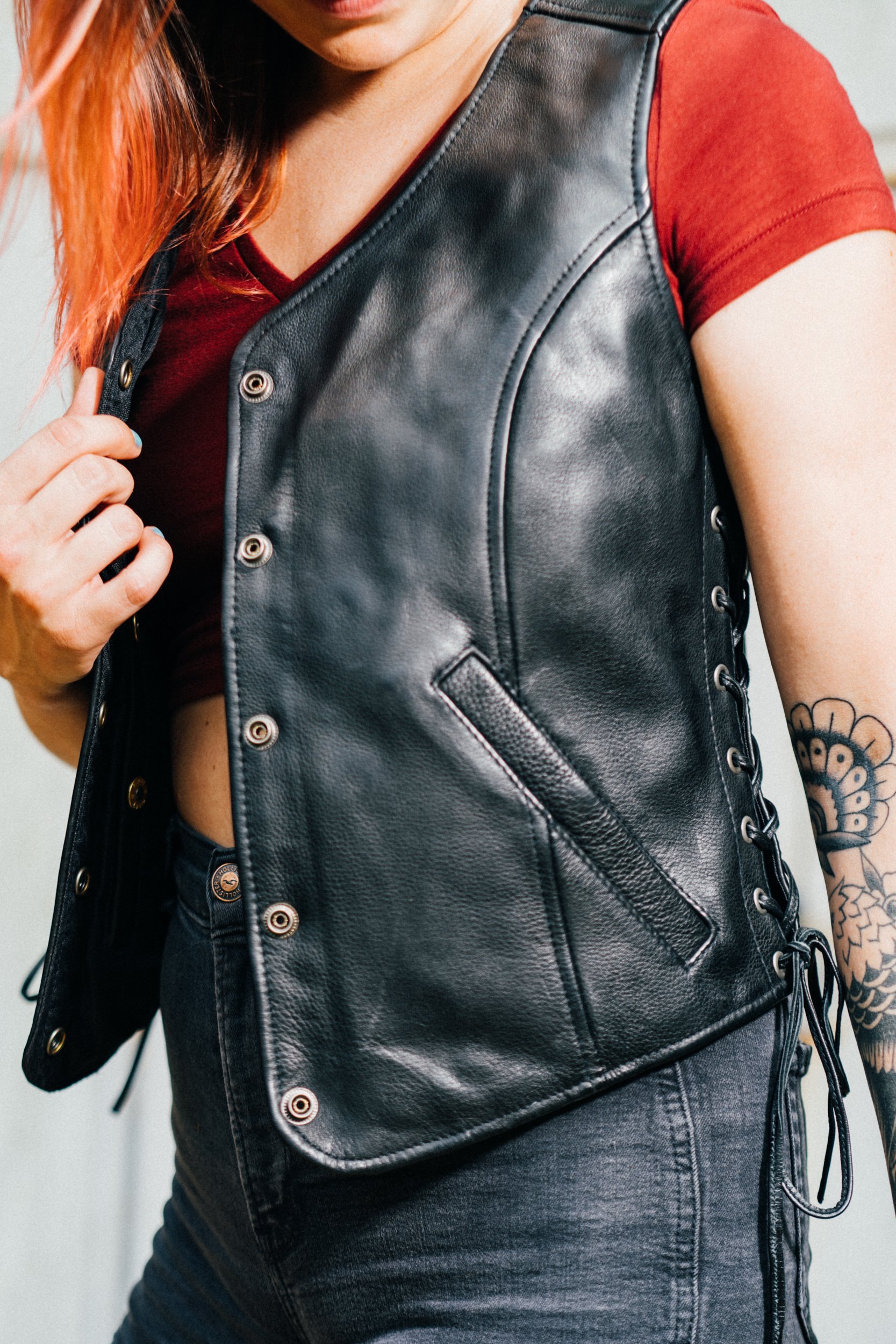 Honey Badger leather vest for women featuring five snap closure, two inner gun pockets, and stylish side lace detailing.