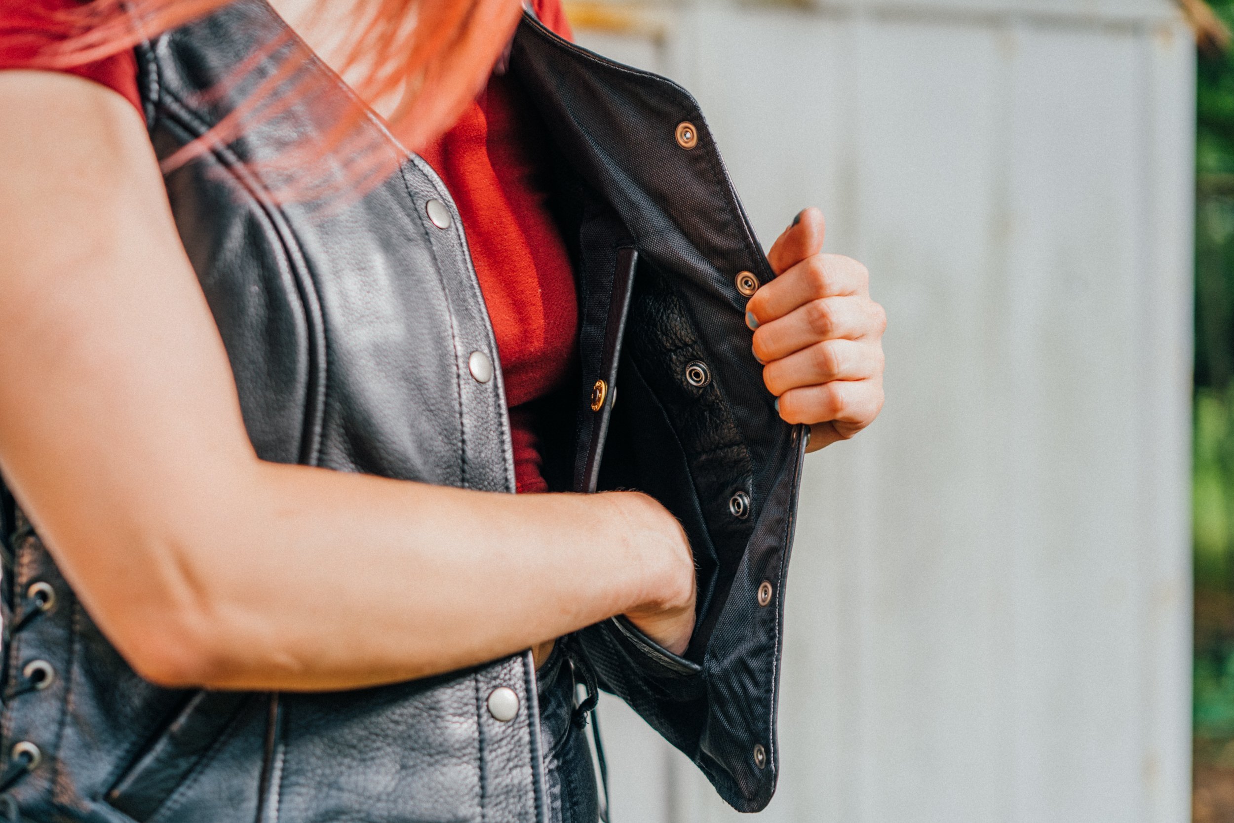 Honey Badger leather vest for women featuring five snap closure, two inner gun pockets, and stylish side lace detailing.