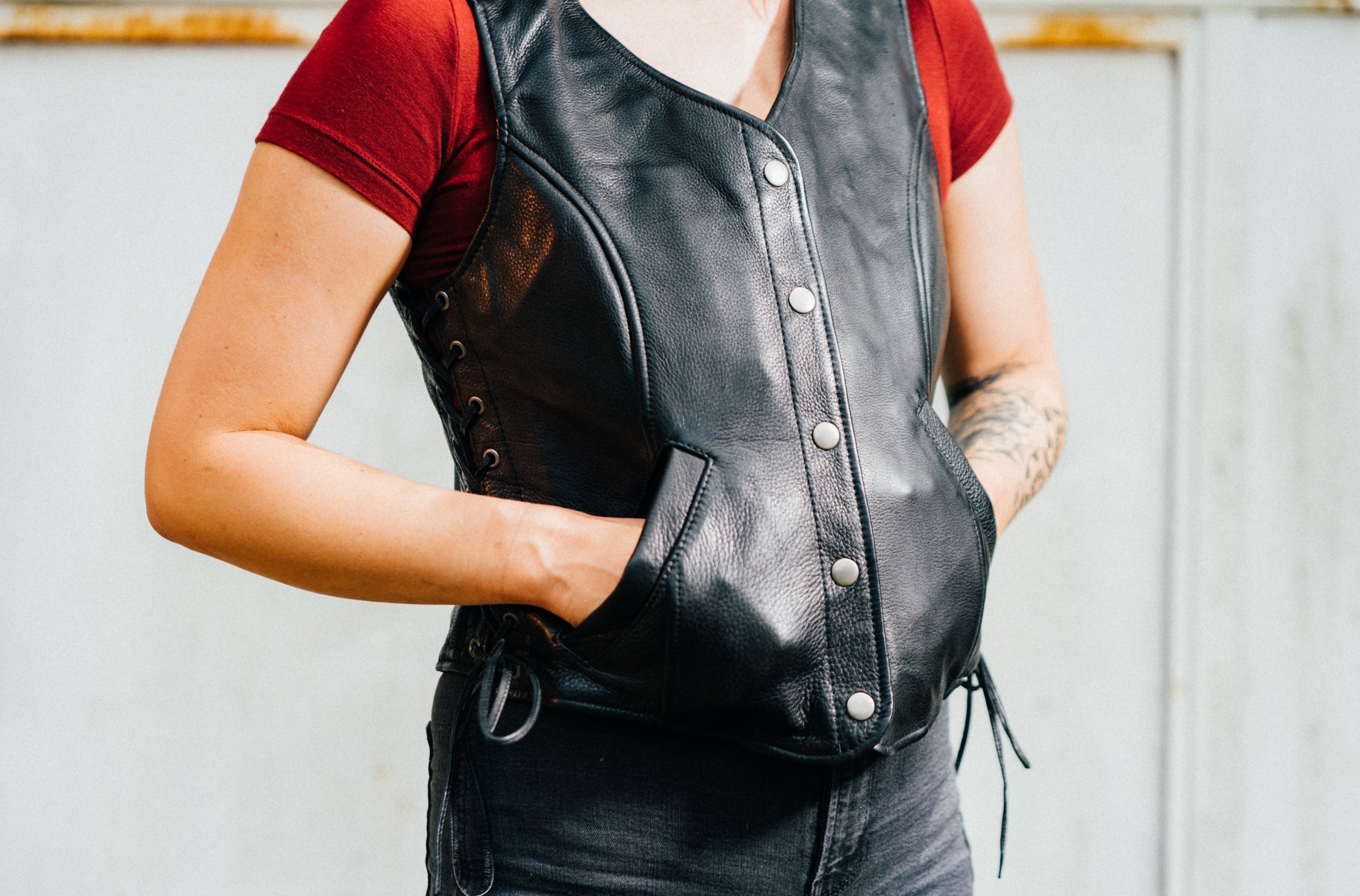 Honey Badger leather vest for women featuring five snap closure, two inner gun pockets, and stylish side lace detailing.