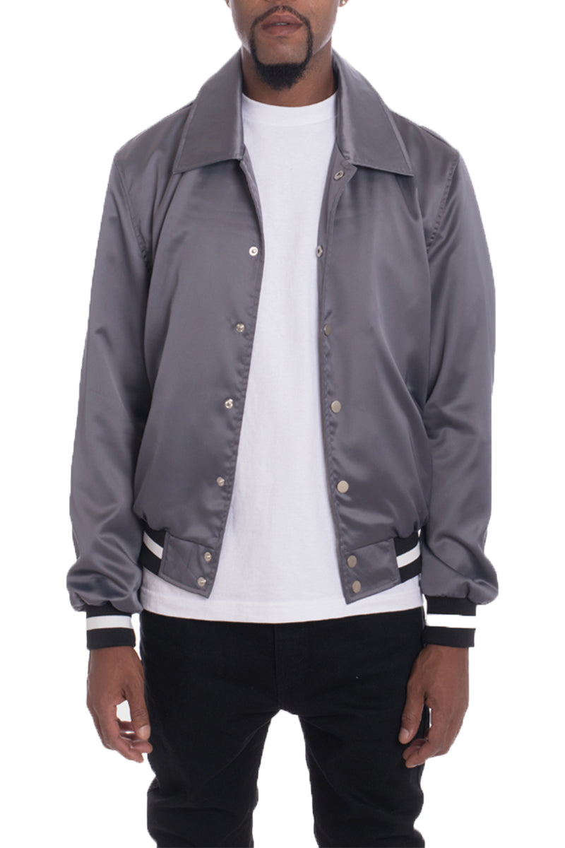 A stylish Luxe Satin Bomber jacket in a rich color, featuring a snap button closure and a single inner chest pocket, displayed on a mannequin.