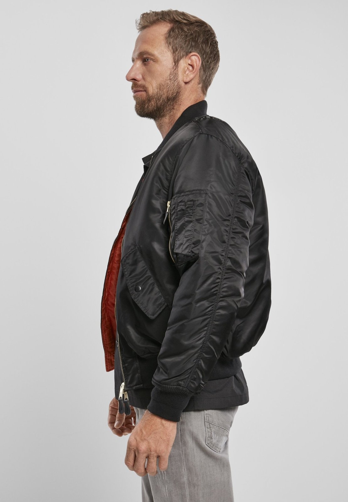 MA1 Bomber Jacket in durable nylon with orange lining, featuring side pockets and knitted cuffs.