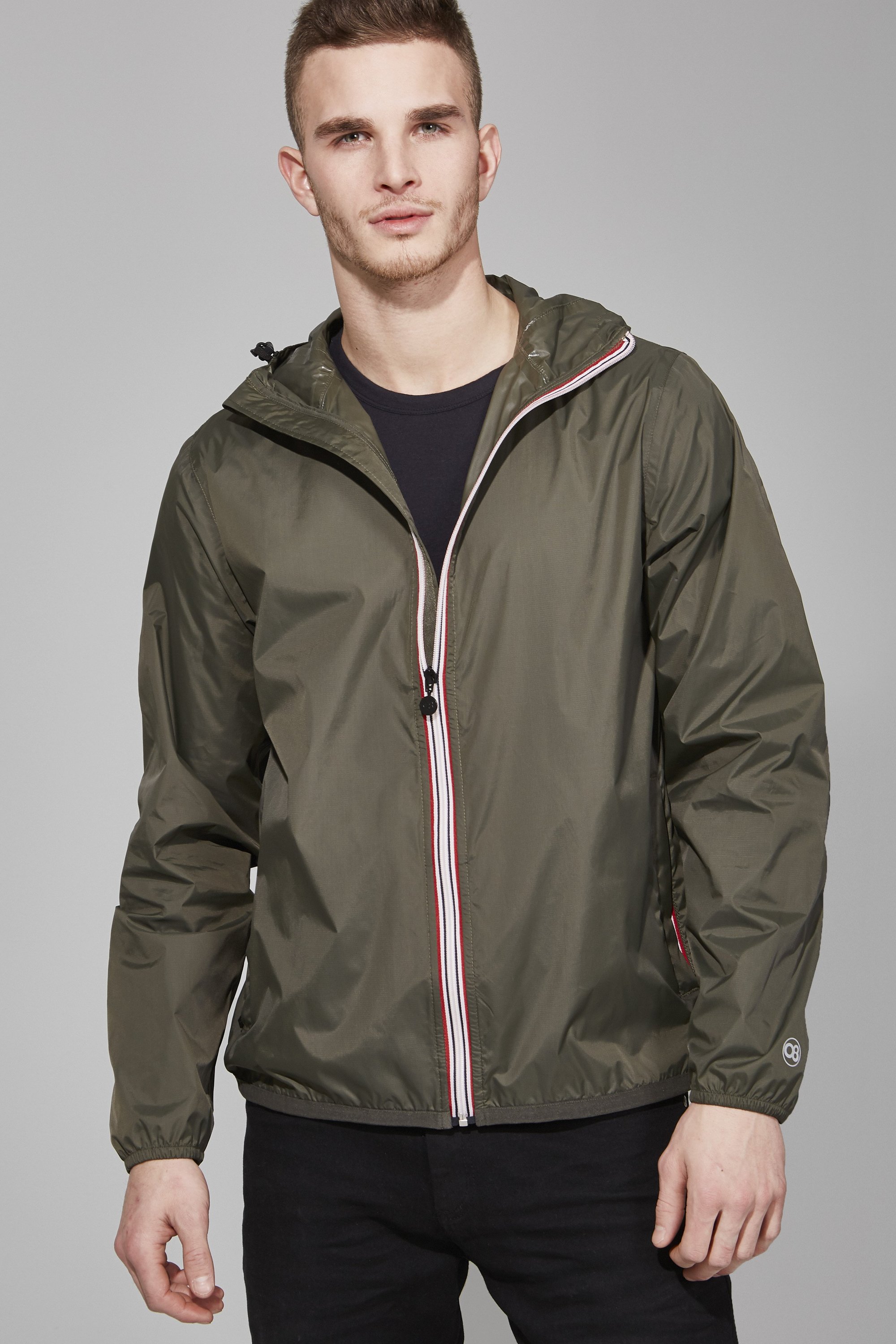 Men's torba full zip packable rain jacket in a stylish design, showcasing its waterproof fabric and packable feature.