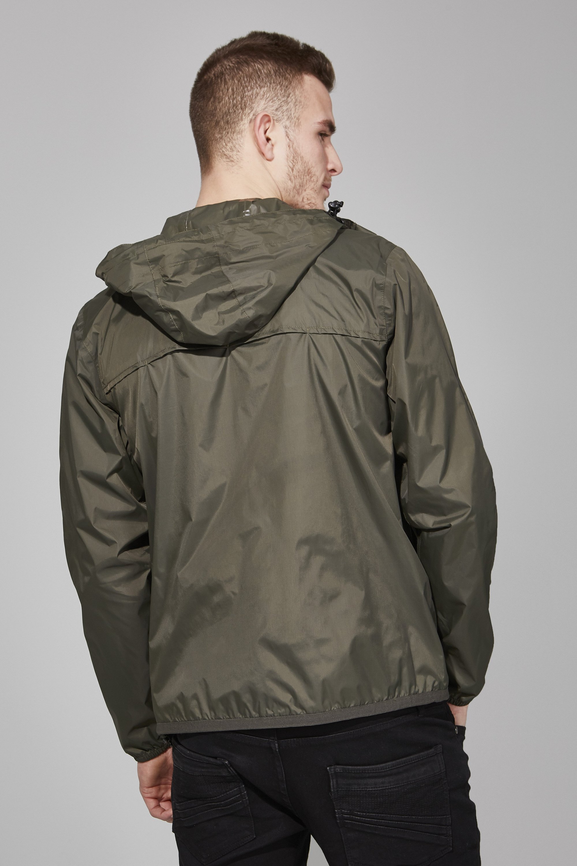 Men's torba full zip packable rain jacket in a stylish design, showcasing its waterproof fabric and packable feature.