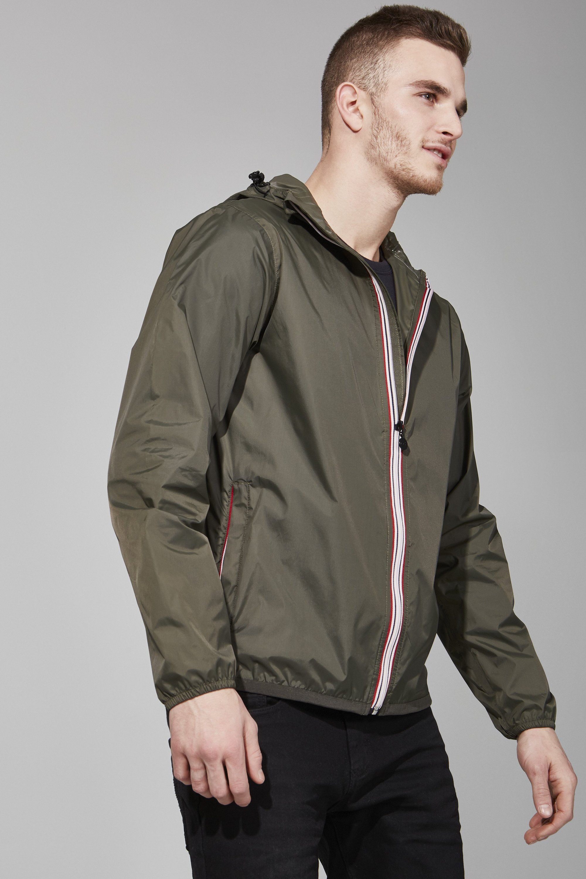 Men's torba full zip packable rain jacket in a stylish design, showcasing its waterproof fabric and packable feature.