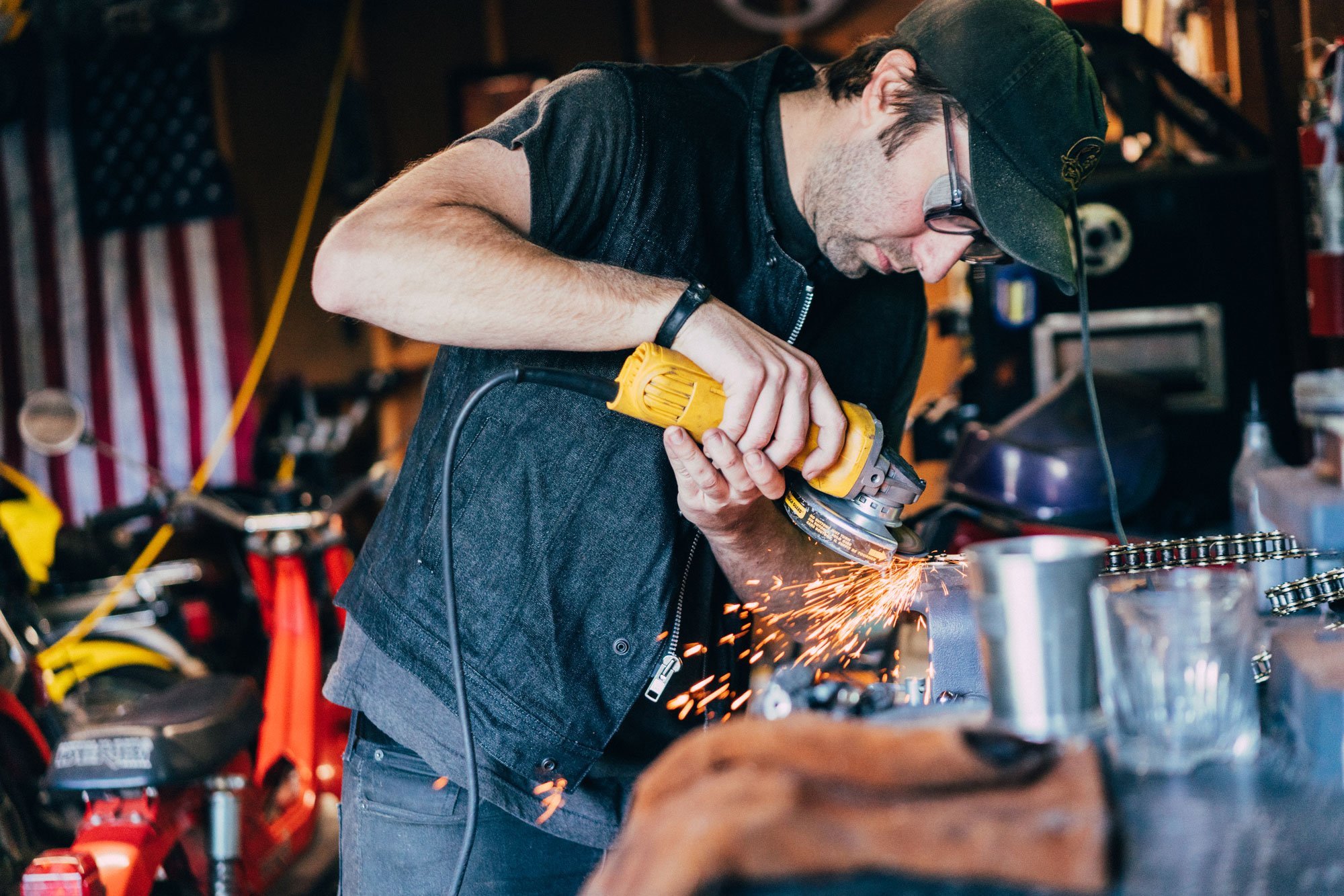 Murdock Men's Motorcycle Denim Vest featuring a roll-up collar, buttoned pockets, and rugged raw denim fabric.