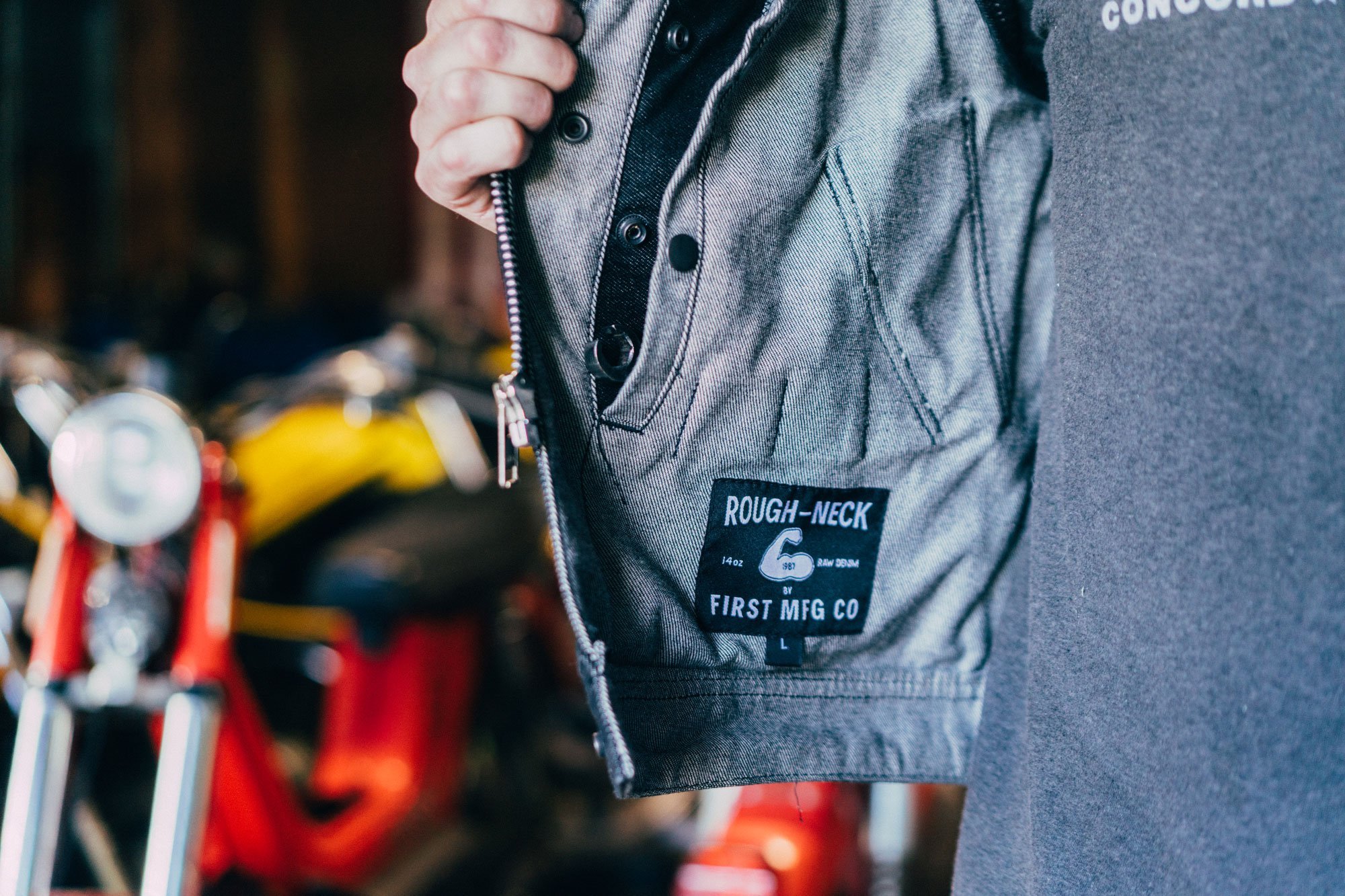 Murdock Men's Motorcycle Denim Vest featuring a roll-up collar, buttoned pockets, and rugged raw denim fabric.